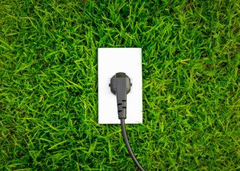 Energy concept outlet in fresh spring green grass