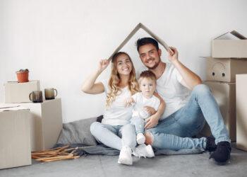Family moving. People use a boxes. Little boy with parents.