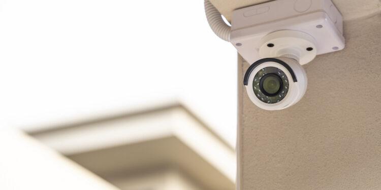 CCTV on the pillar of a house on white background