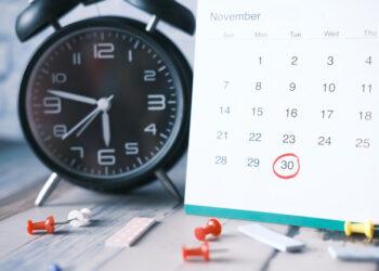 deadline concept with calendar and alarm clock on table .