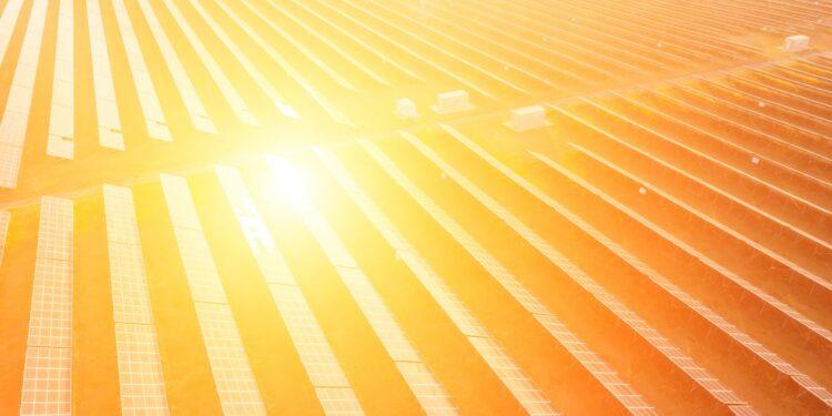Aerial top view of a solar panels power plant. Photovoltaic solar panels at sunrise and sunset in countryside from above. Modern technology, climate care, earth saving, renewable energy concept