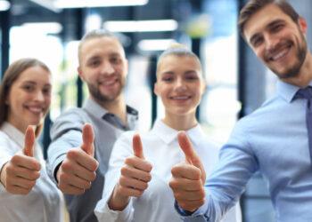 Successful business people with thumbs up and smiling